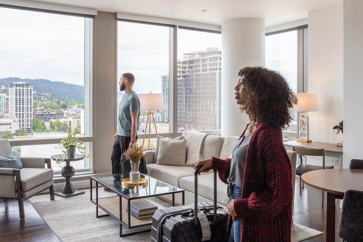 couple arriving at apartment with luggage