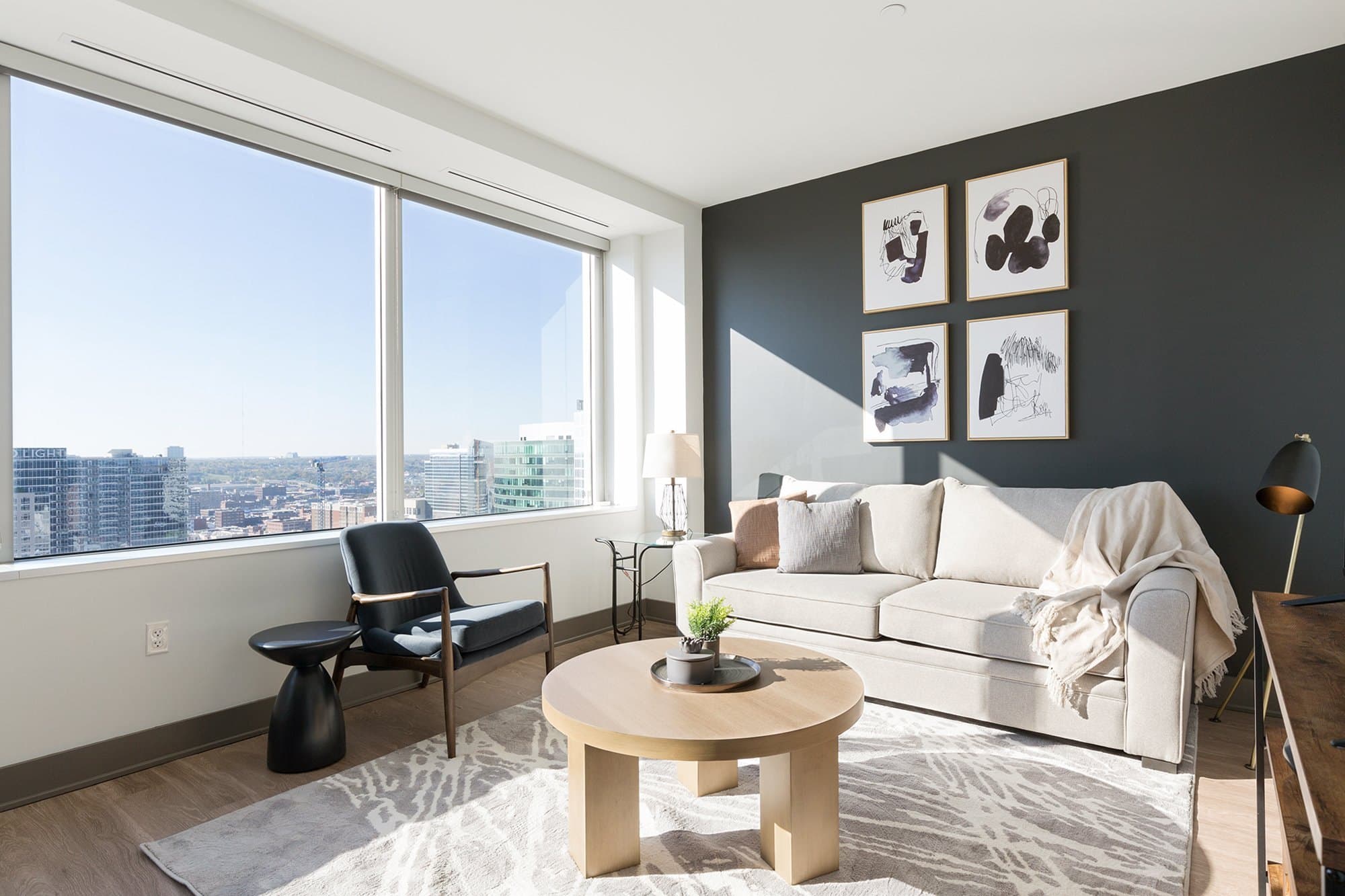 A furnished Landing apartment: living room with floor-to-ceiling windows and a city view