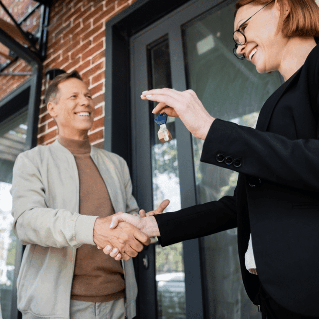 Woman handing keys to a man