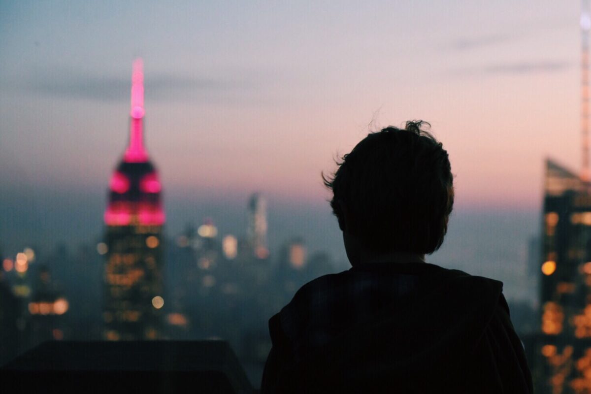 A person looks out at the New York City Skyline