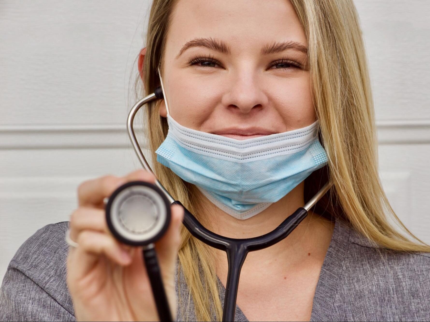 A smiling travel nurse