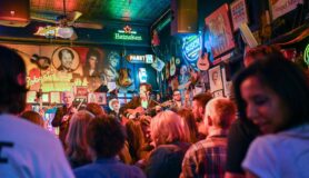A group of people listening to a band at a country bar in Nashville, Tennessee.