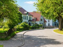 Beautiful street with modern residential houses in summer sunny day in the suburbs.