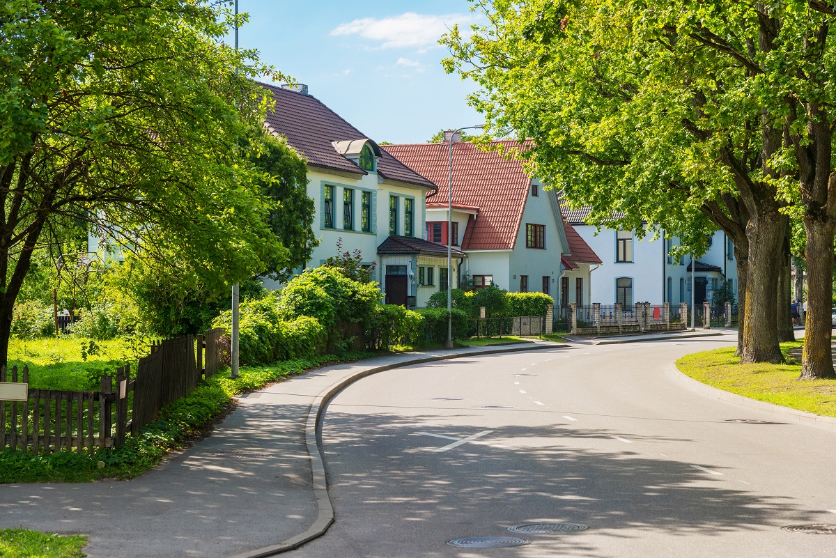 Beautiful street with modern residential houses in summer sunny day in the suburbs.