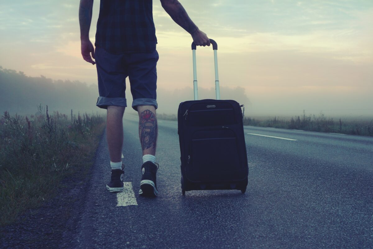 Man walks with suitcase in Denver
