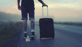Man walks with suitcase in Denver