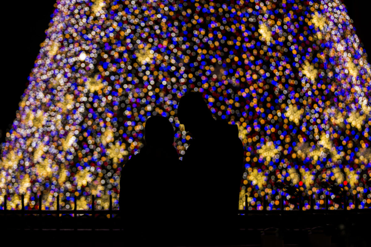 Couple in front of a Christmas tree in Chicago