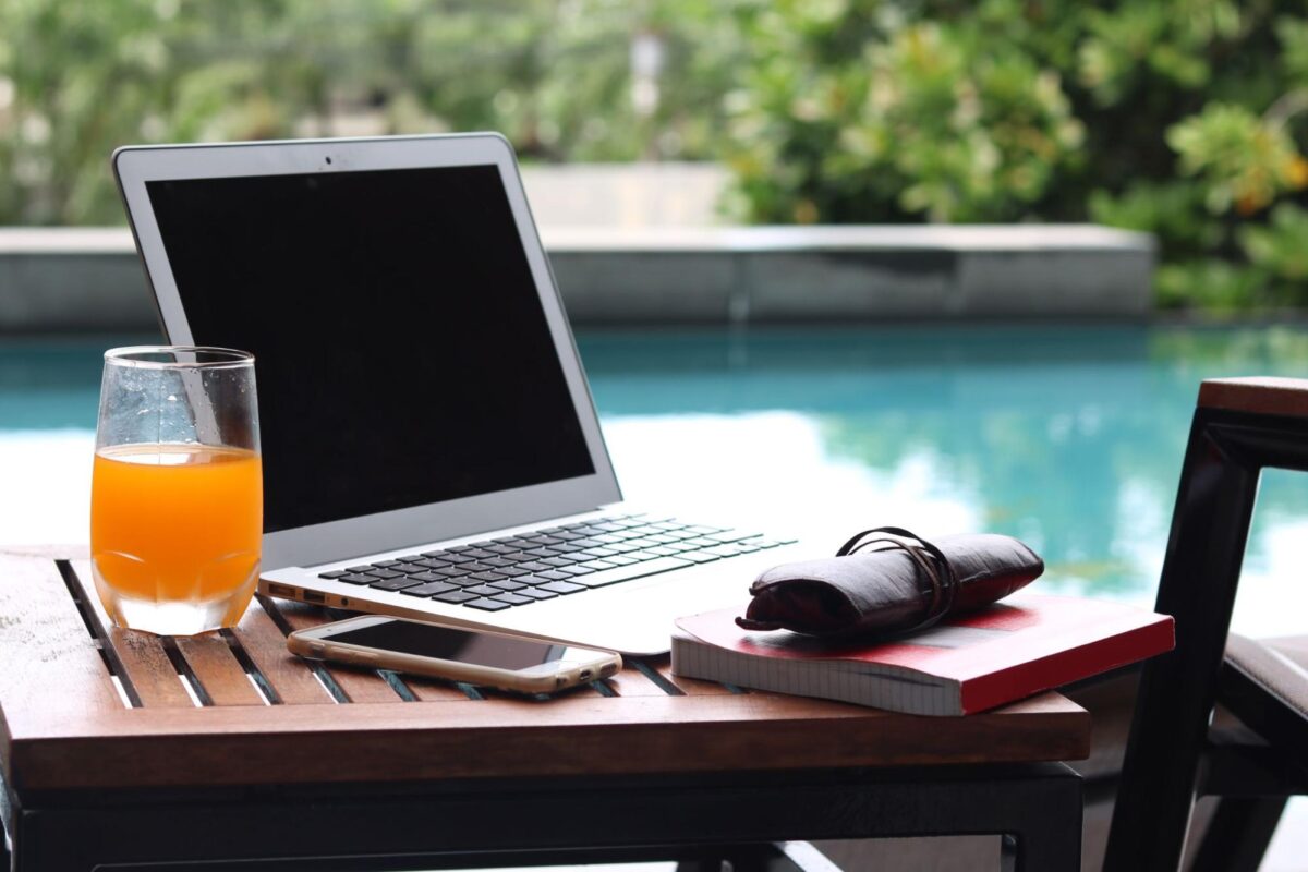 Work from anywhere setup with a laptop near a pool.