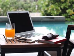 Work from anywhere setup with a laptop near a pool.