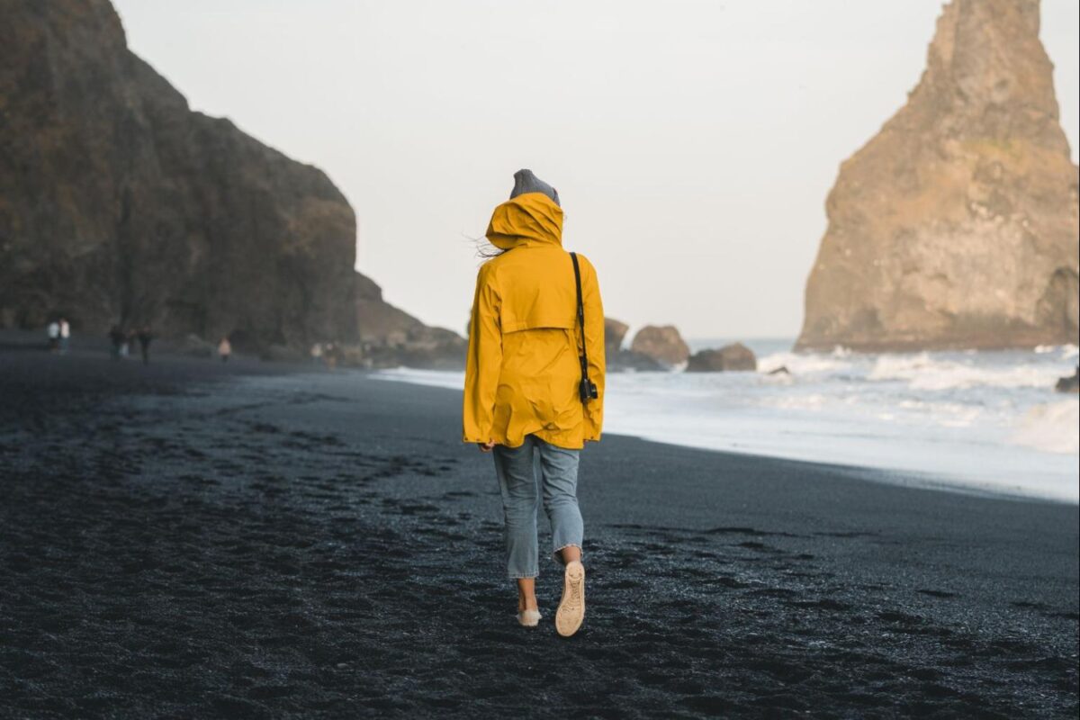 Woman walking on the beach in the Pacific Northwest.