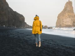 Woman walking on the beach in the Pacific Northwest.