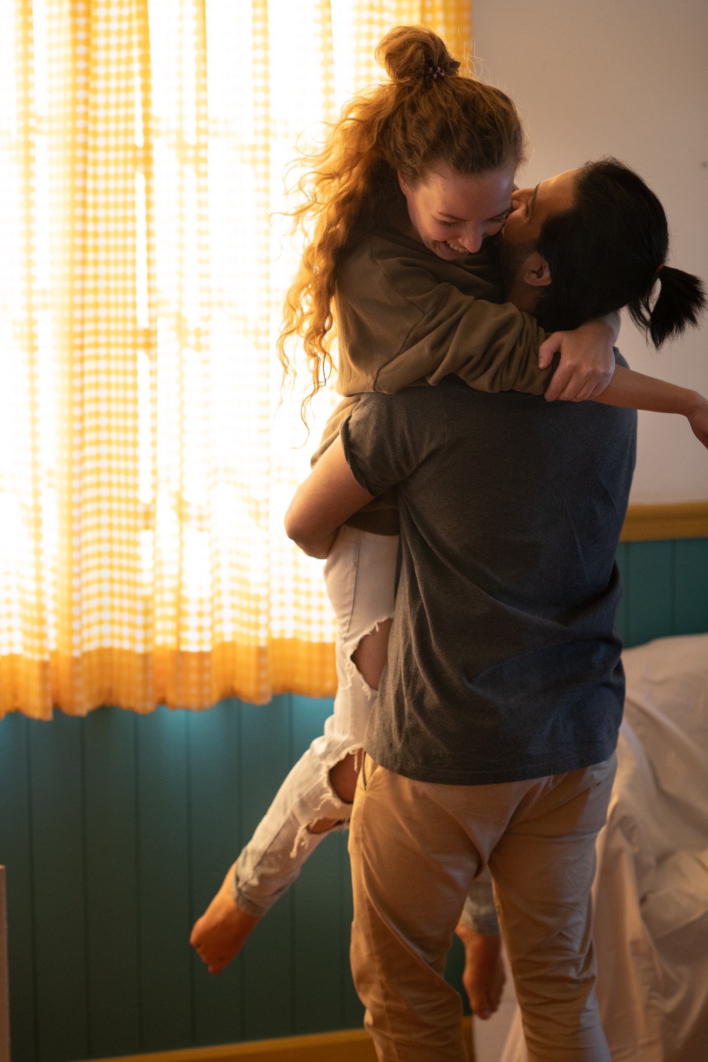 Couple embraces in their apartment after moving in together.