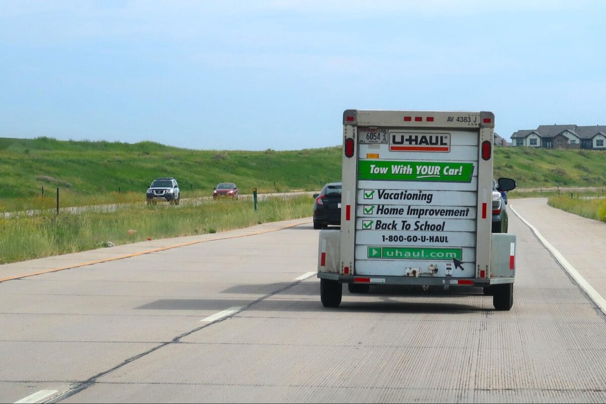 Moving van drives down the highway as part of a cross-country move.