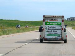 Moving van drives down the highway as part of a cross-country move.