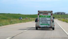 Moving van drives down the highway as part of a cross-country move.