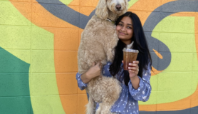 Digital nomad Vinisha poses with her dog.