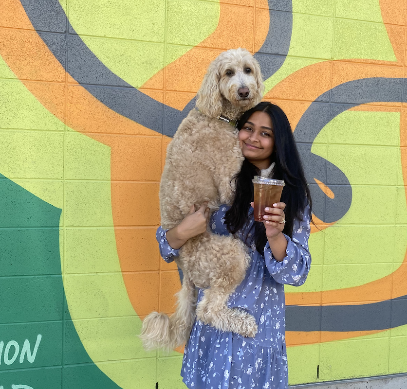 Digital nomad Vinisha poses with her dog.
