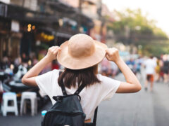 Woman explores a new city after using these traveling safety tips.