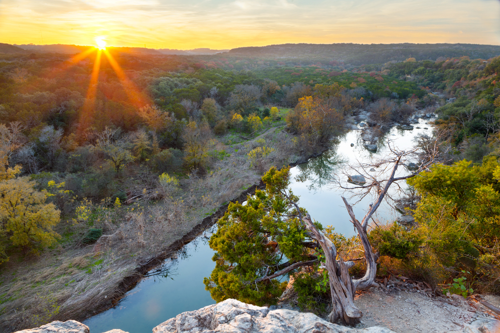 The sun sets over the Barton Creek Greenbelt in Austin, Texas.