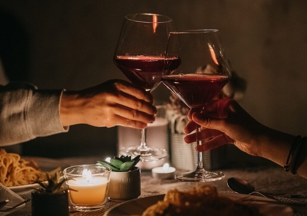 Couple clinks glasses at one of the most romantic restaurants in Nashville