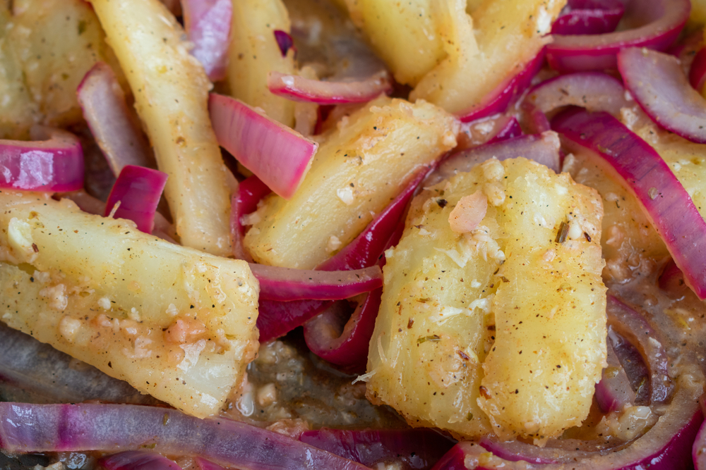 Yuca Con Mojo: Cuban style yuca and red onions in a citrus and garlic mojo sauce