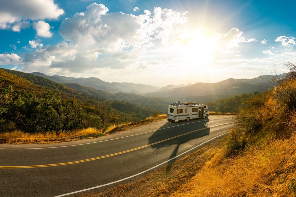 Mountain view with a roadside parked motorhome on a road trip