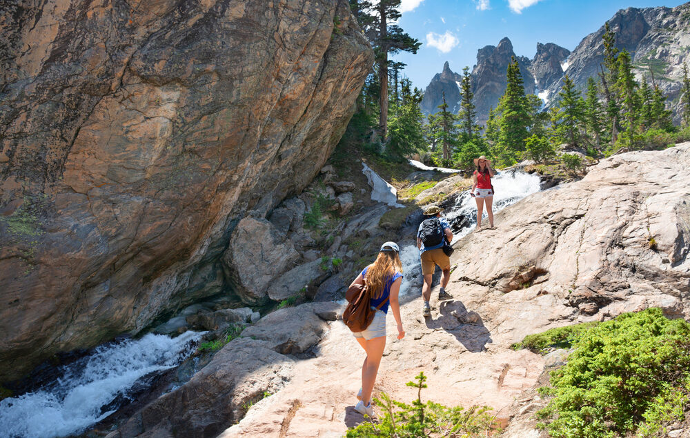 Three people hiking at Rocky Mountain National Park near Denver, CO.