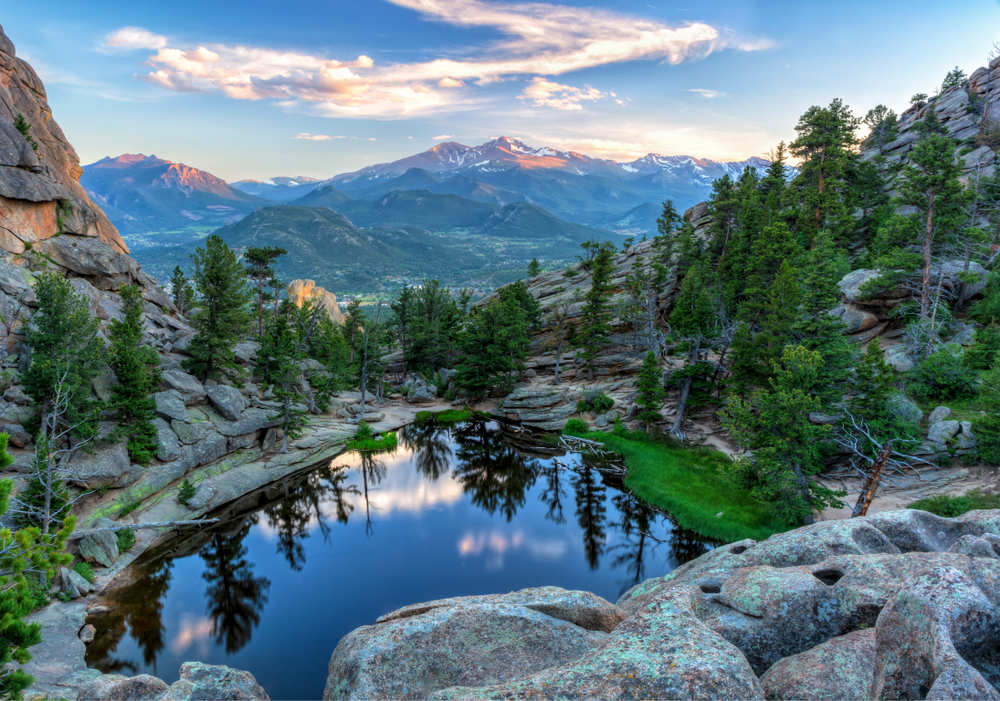 The last evening sunshine hits Longs Peak and The Crags above Gem Lake in Rocky Mountain National Park, Estes Park, Colorado