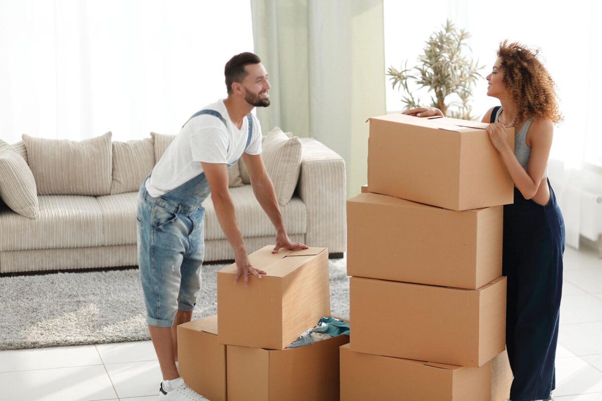 Couple packs up cardboard boxes before moving to another state