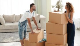 Couple packs up cardboard boxes before moving to another state