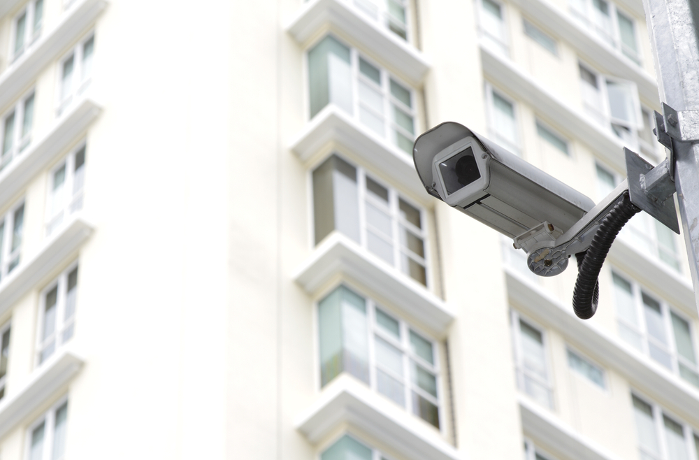 A security camera in front of an apartment block