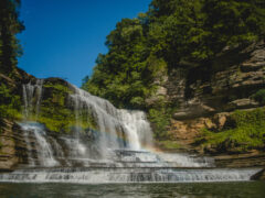 A blue sky above a roaring waterfall in Tennessee