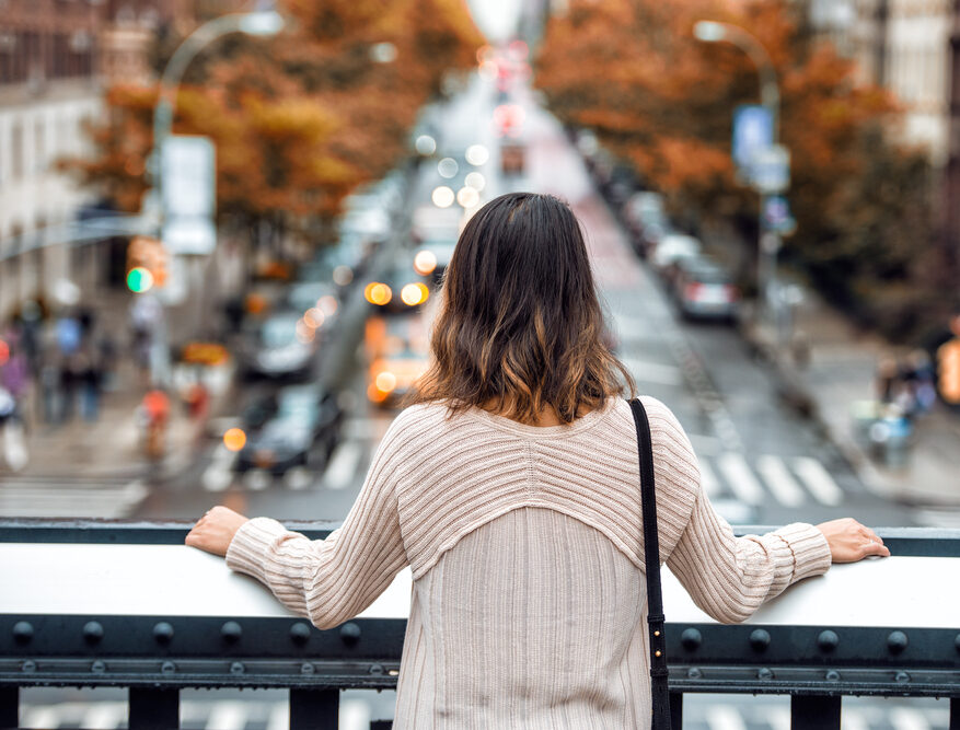 Slow traveler woman looking out over New York City.