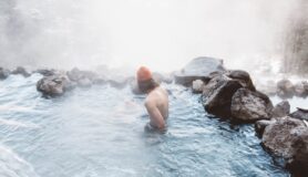 Man sits in steamy Jemez Hot Springs in New Mexico, one of the best hot springs in the United States