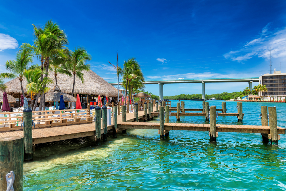 Tropical beach and pier on sunny beach in Key Largo, Florida keys islands. Tropical beach and pier on sunny beach in Key Largo, Florida keys islands.