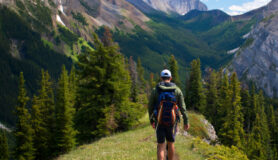 Man hikes through the best hiking trails in the U.S.