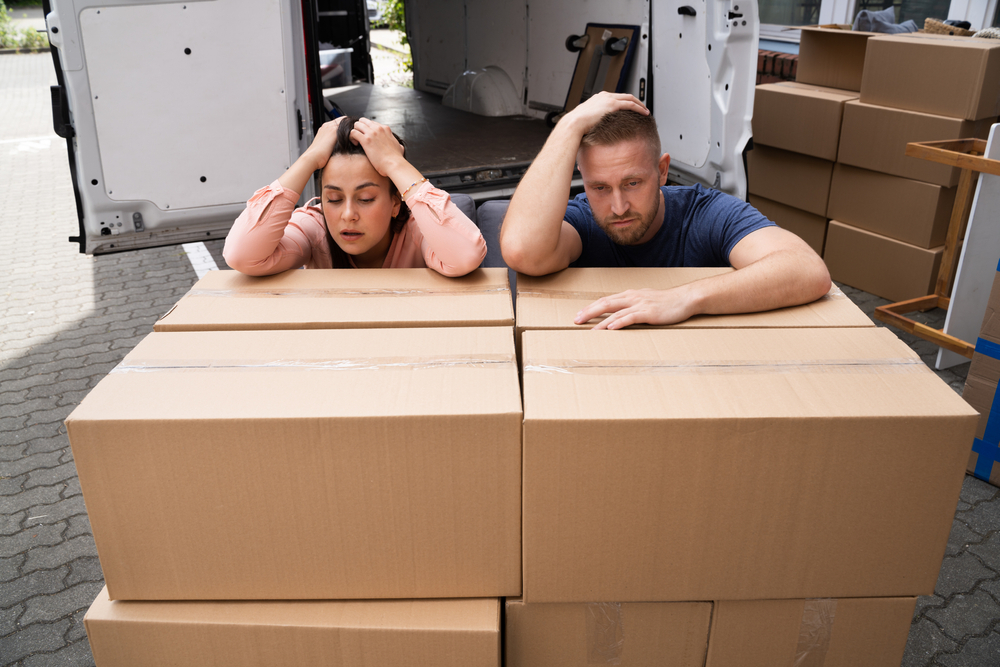 Home Move Stress. Frustrated Couple Moving Apartment