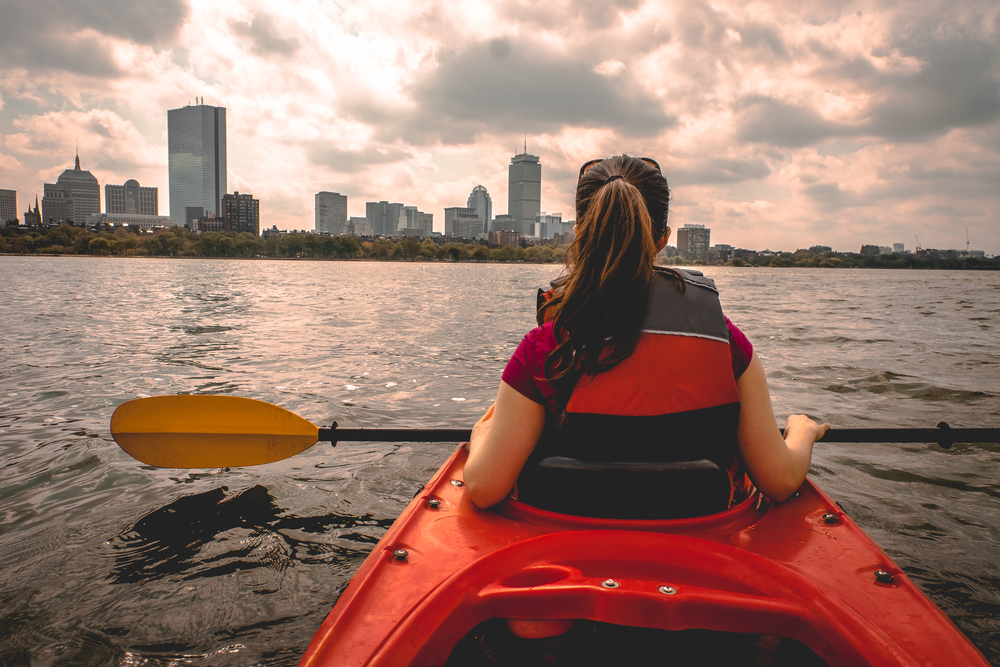 Lady paddling the kayak in Boston