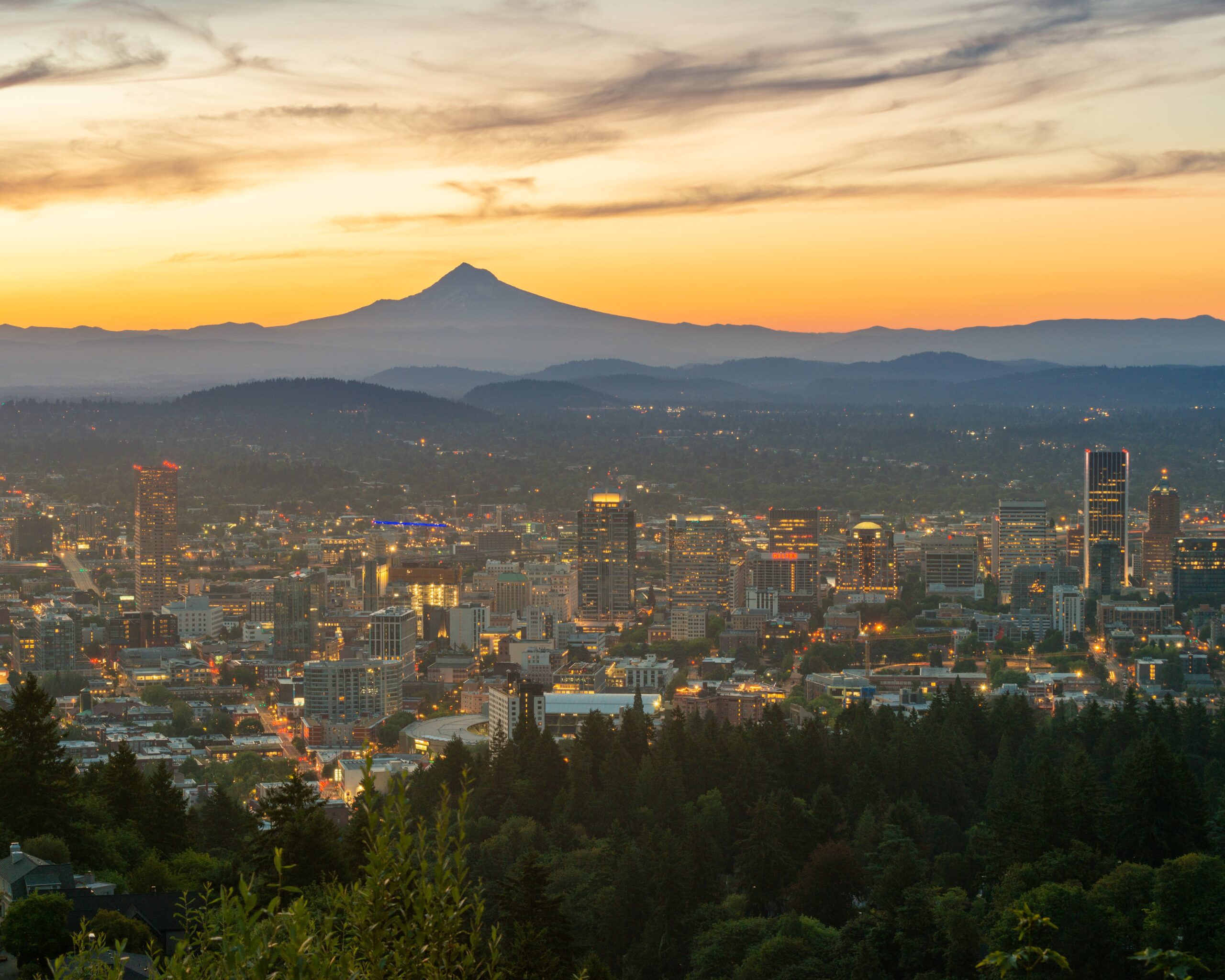 View of Portland, Oregon at sunset with Mount Hood in the background.