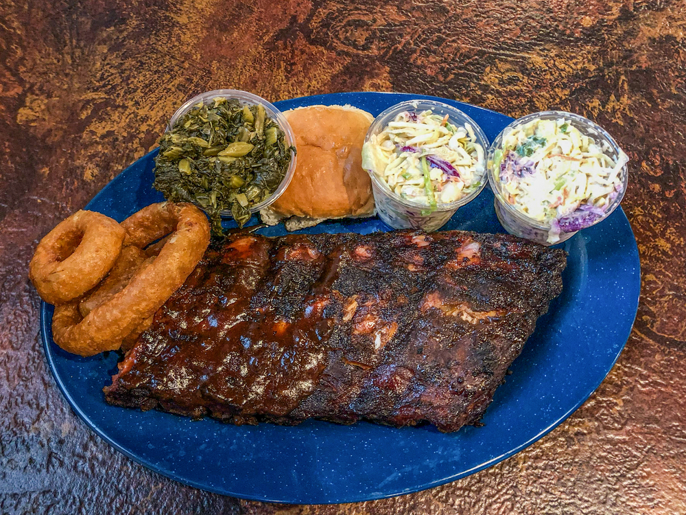 Slab of meat and sides on a table at famous bbq restaurant in Memphis, Tennessee