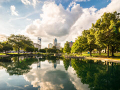 A park and pond with the city skyline in the background in Charlotte, North Carolina.
