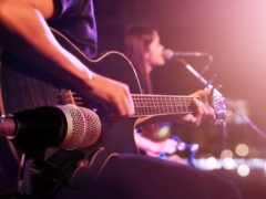 A guitarist takes the stage at a live music venue in Atlanta, GA.
