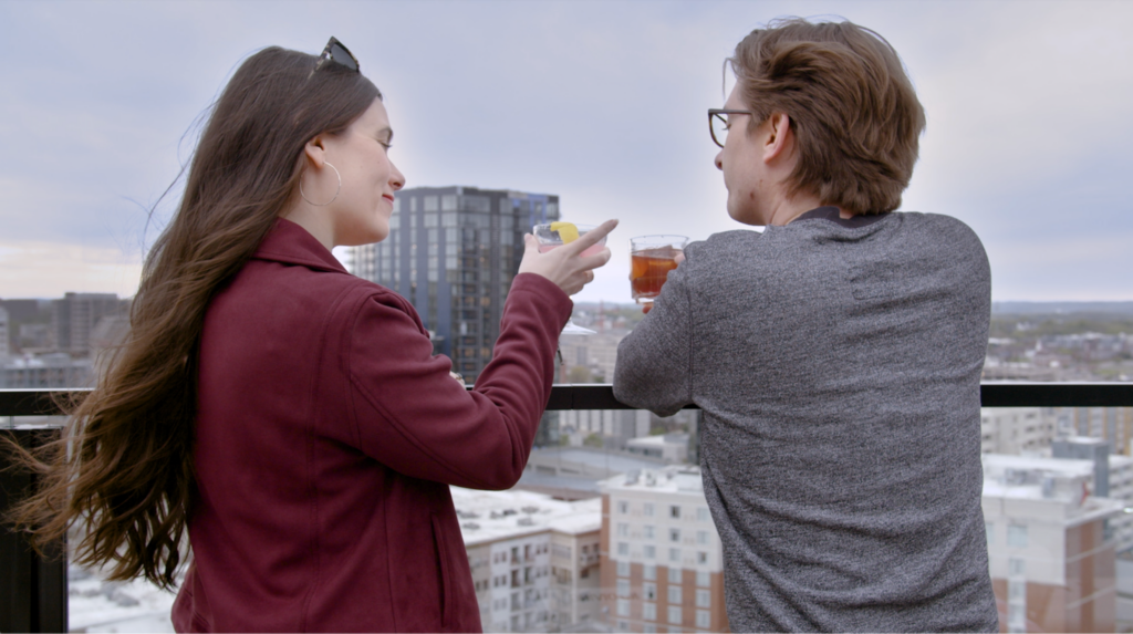 Adam and Roxanna toast over the Nashville skyline after moving there.