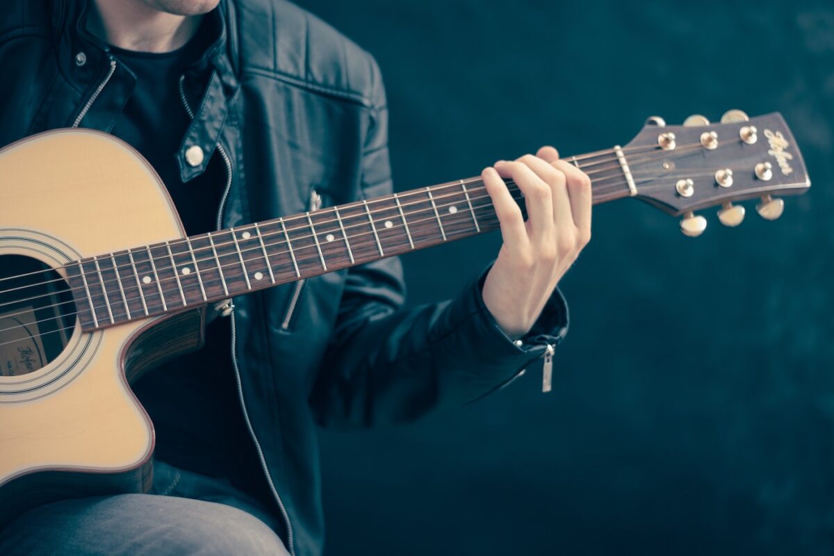 Man plays guitar in one of the best live music venues in Austin, Texas.