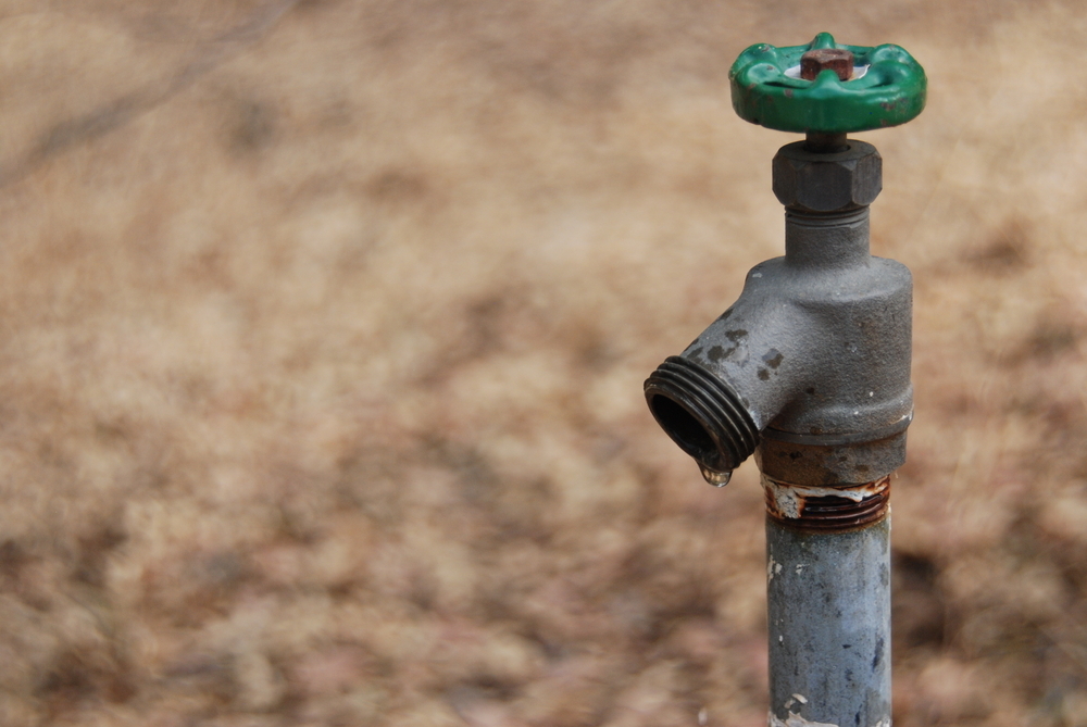 A dripping spigot on the ranch in California. Drought conditions. Extreme measures necessary. Depleted water resources. A dripping spigot on the ranch in California. Drought conditions. Extreme measures necessary. Depleted water resources.