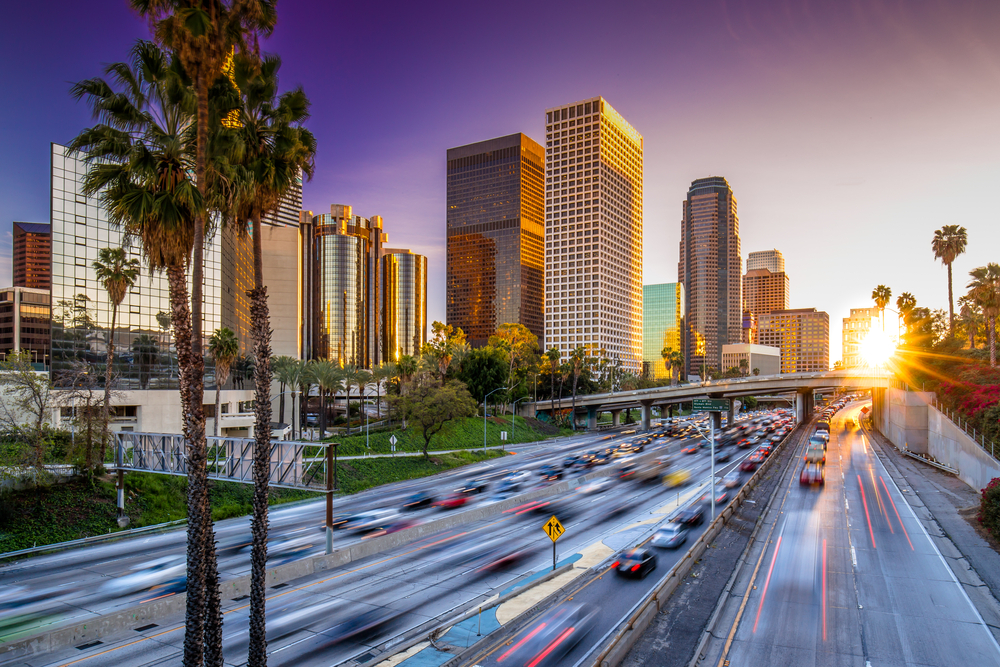 Los Angeles downtown buildings and highway car traffic at sunset Los Angeles downtown buildings and highway car traffic at sunset