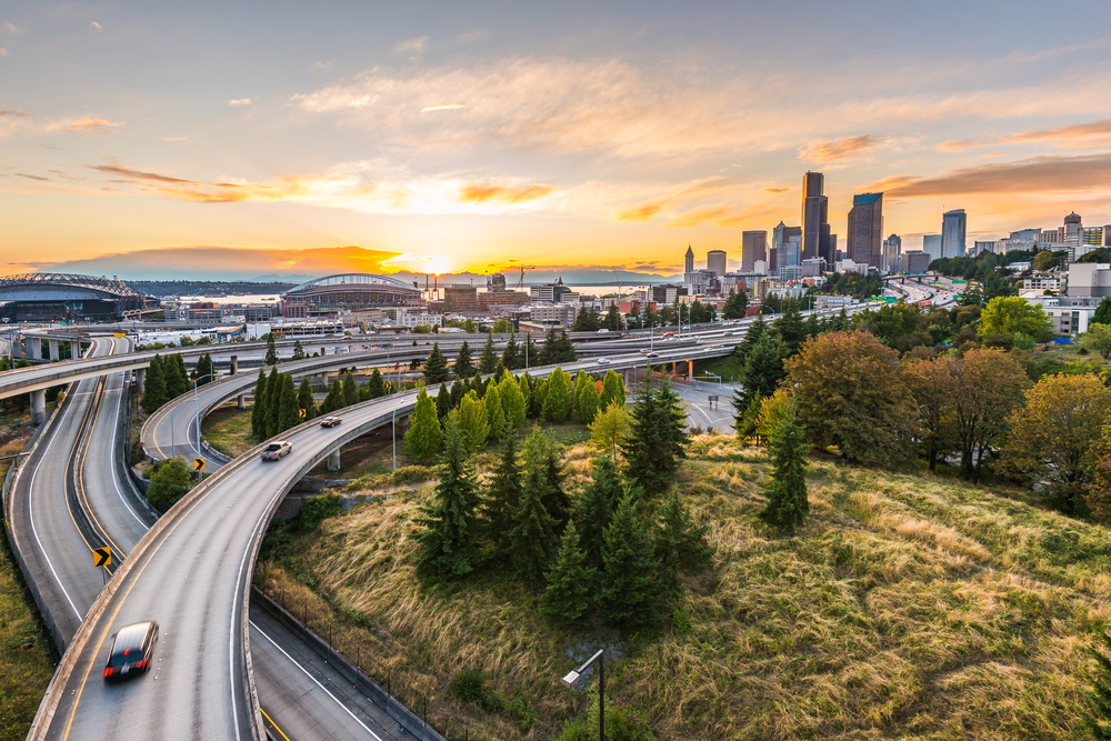 Seattle skylines and Interstate freeways converge with Elliott Bay and the waterfront background of in sunset time, Seattle, Washington State, USA.