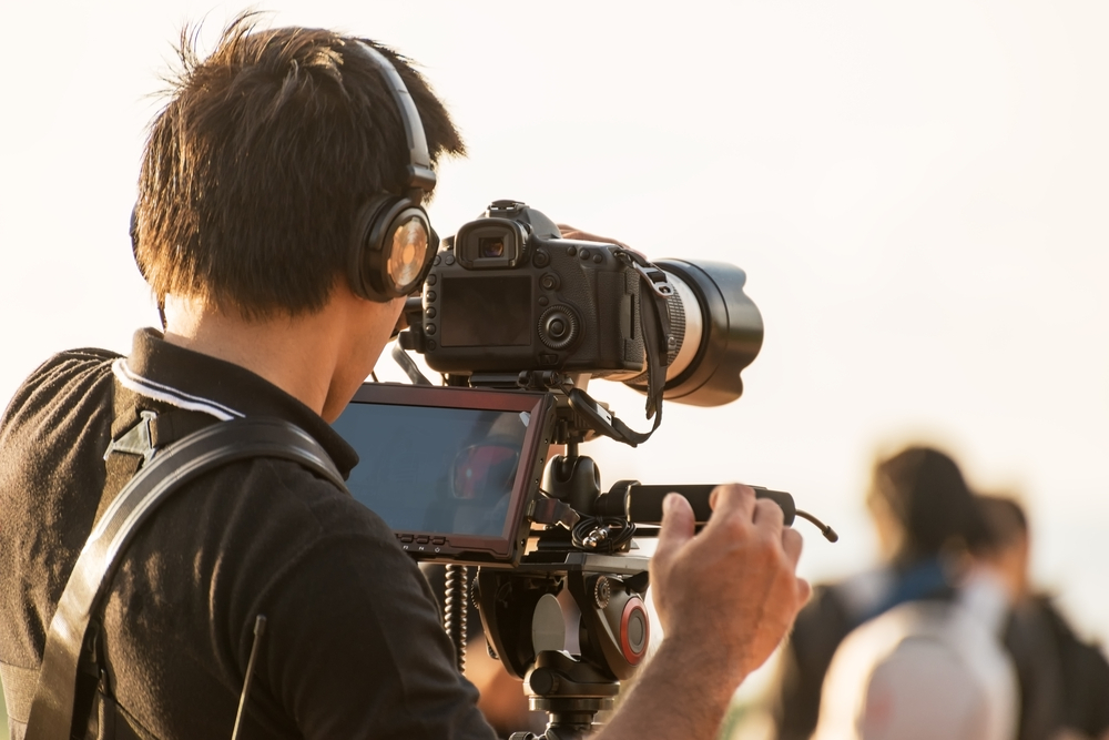 Video camera man operator working with professional equipment,filming recording