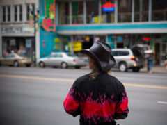 Person wearing a cowboy hat, standing on Lower Broadway in Nashville, Tennessee.
