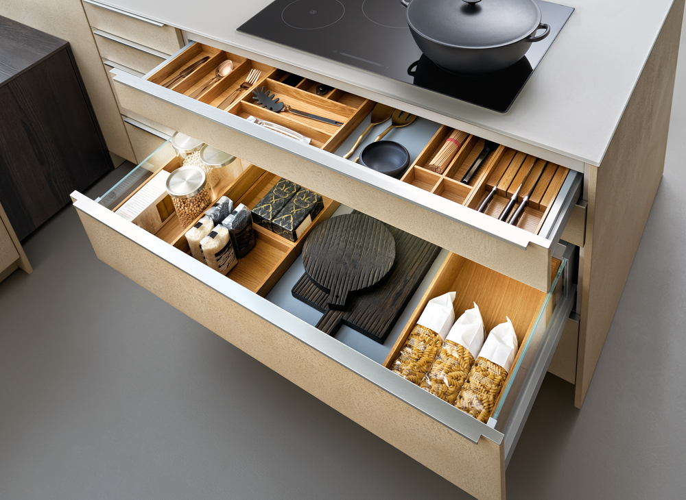 Modern kitchen, Open drawers, Set of cutlery trays in kitchen drawer. Solid oak wood cutlery drawer inserts. Modern kitchen, Open drawers, Set of cutlery trays in kitchen drawer. Solid oak wood cutlery drawer inserts.